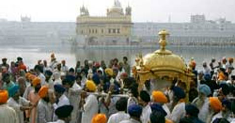 Devotees-carry-a-gold-plated-palanquin-carrying-the-Sikh-holy-book,-Guru-Granth-Sahib-2008-11-12